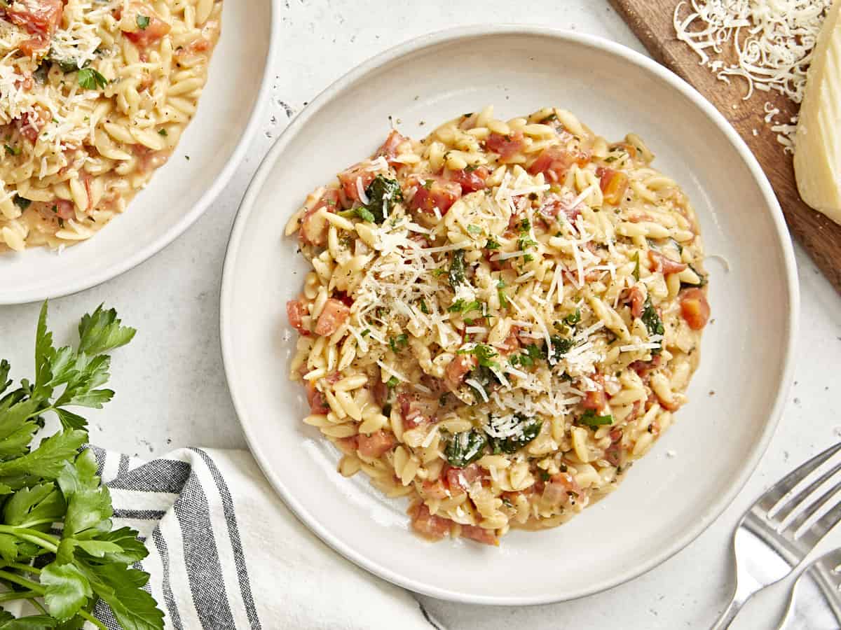 Draufsicht auf eine Portion toskanischen Orzo auf einem weißen Teller.