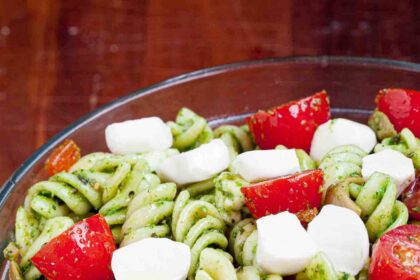 caprese pasta salad with mozzarella and pesto.