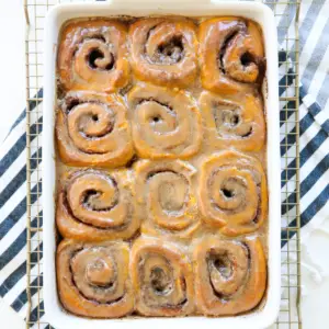 Kürbis-Gewürz-Zimtschnecken in Auflaufform auf Handtuch