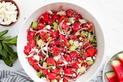 overhead view of watermelon and feta salad in a white bowl.