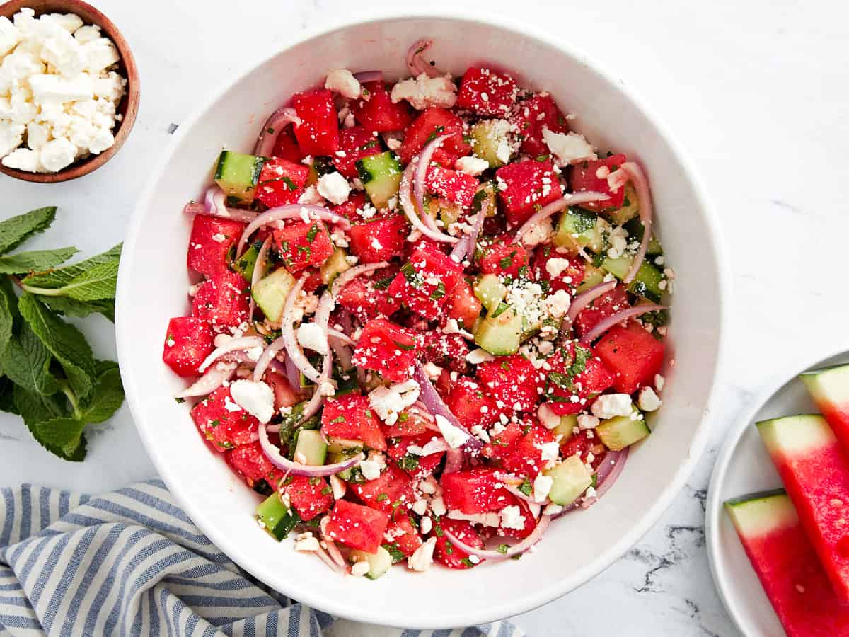 overhead view of watermelon and feta salad in a white bowl.