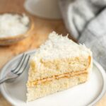 slice of coconut cake on white plate.