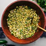 Chipotle Corn Salsa in a large bowl with spoon