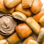 overhead view of texas roadhouse rolls with honey cinnamon butter.