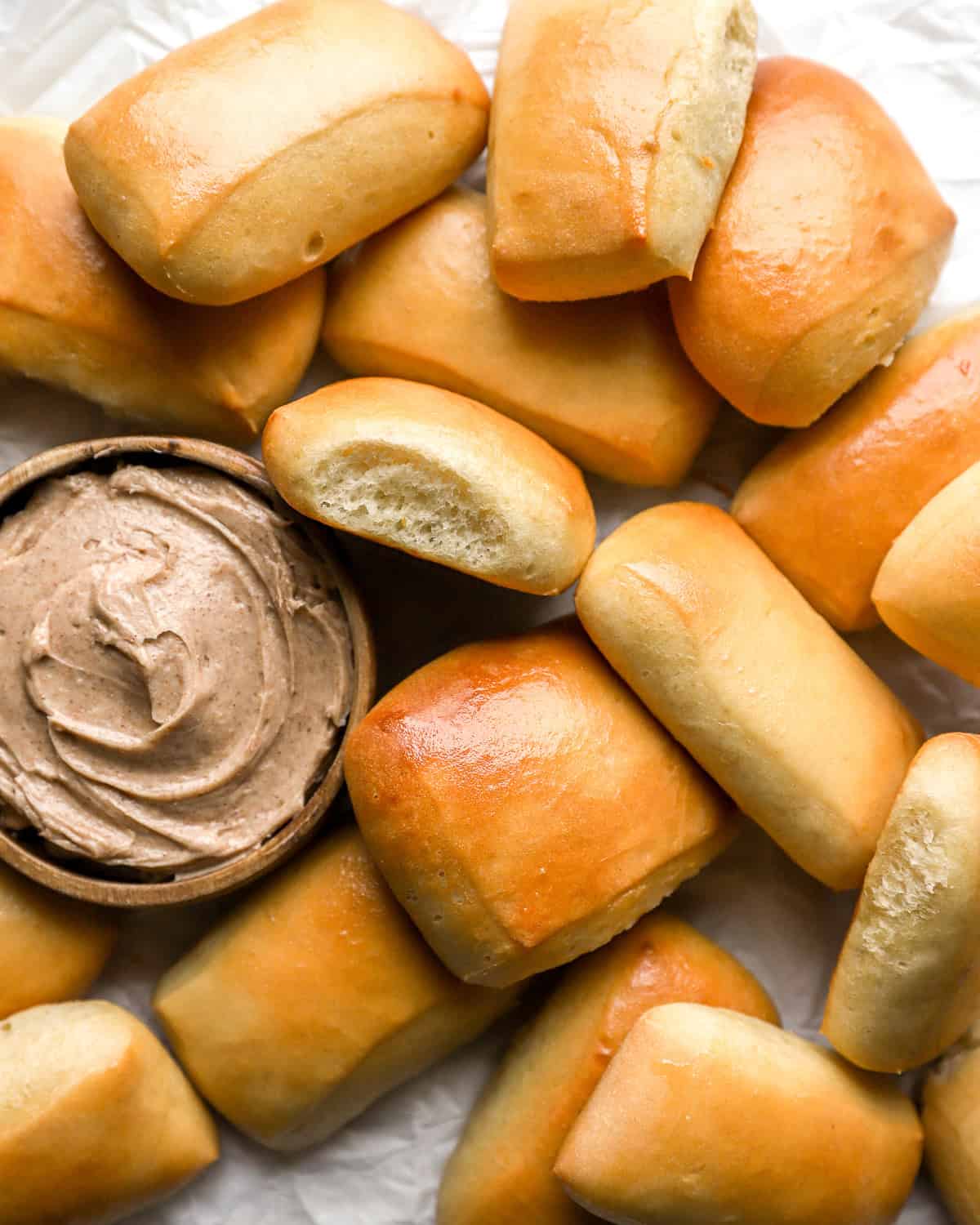 overhead view of texas roadhouse rolls with honey cinnamon butter.