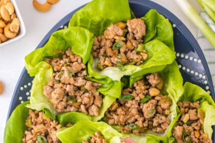 lifting up chicken lettuce wrap from platter