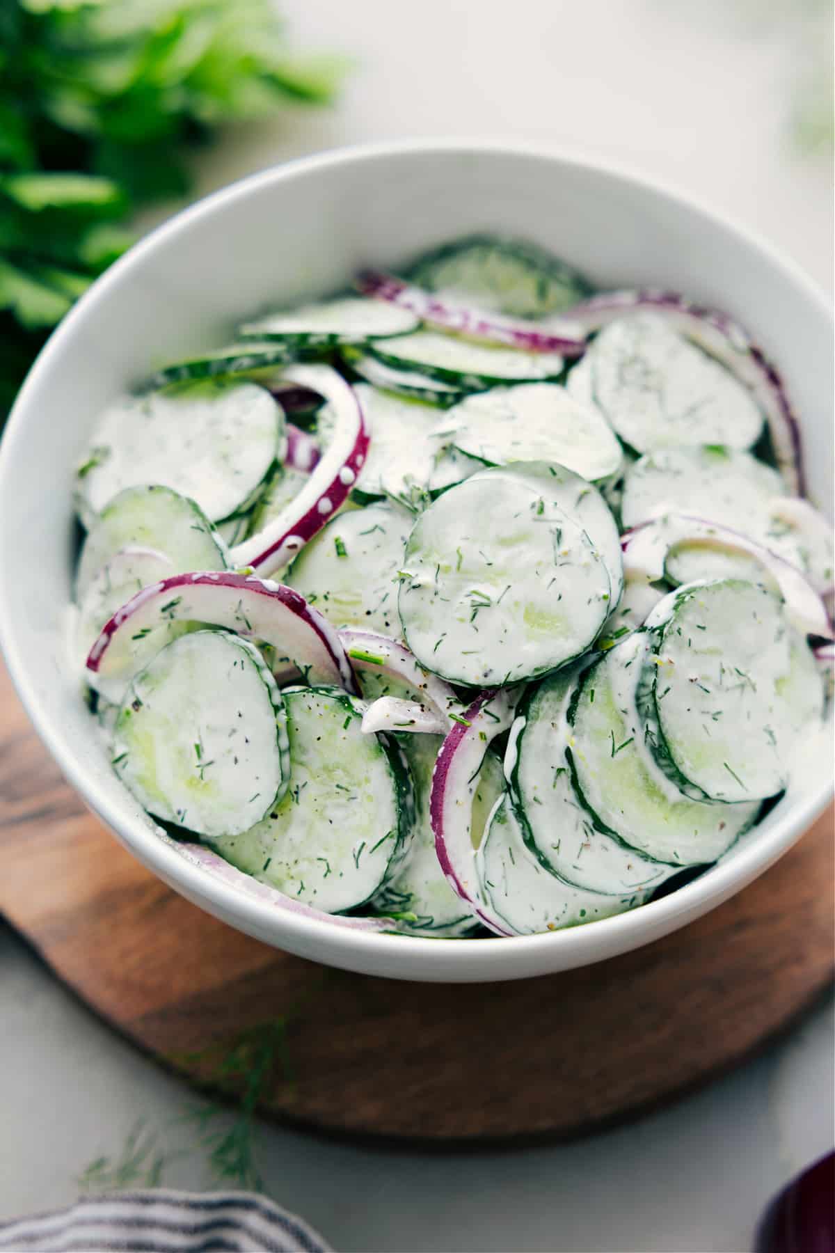 Creamy Cucumber Salad recipe in a bowl ready to be enjoyed.