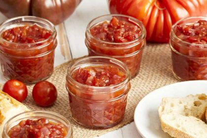 A side view of tomato relish in glass jars.