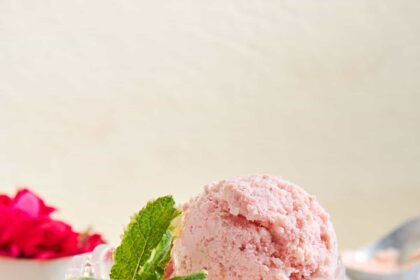 A serving cup of strawberry fruit ice cream.
