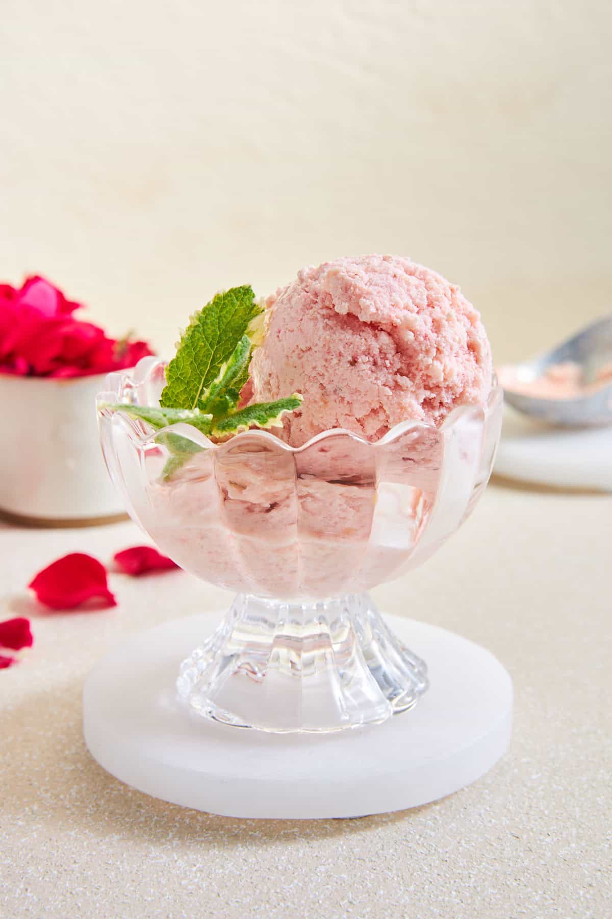 A serving cup of strawberry fruit ice cream.