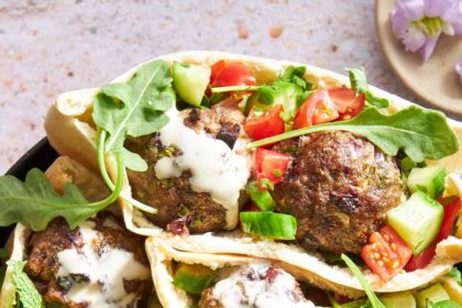 Pita pockets stuffed with tomato and cucumber salad, beef meatballs, and tzatziki.