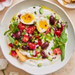 A bowl of whipped cottage cheese salad topped with an egg.