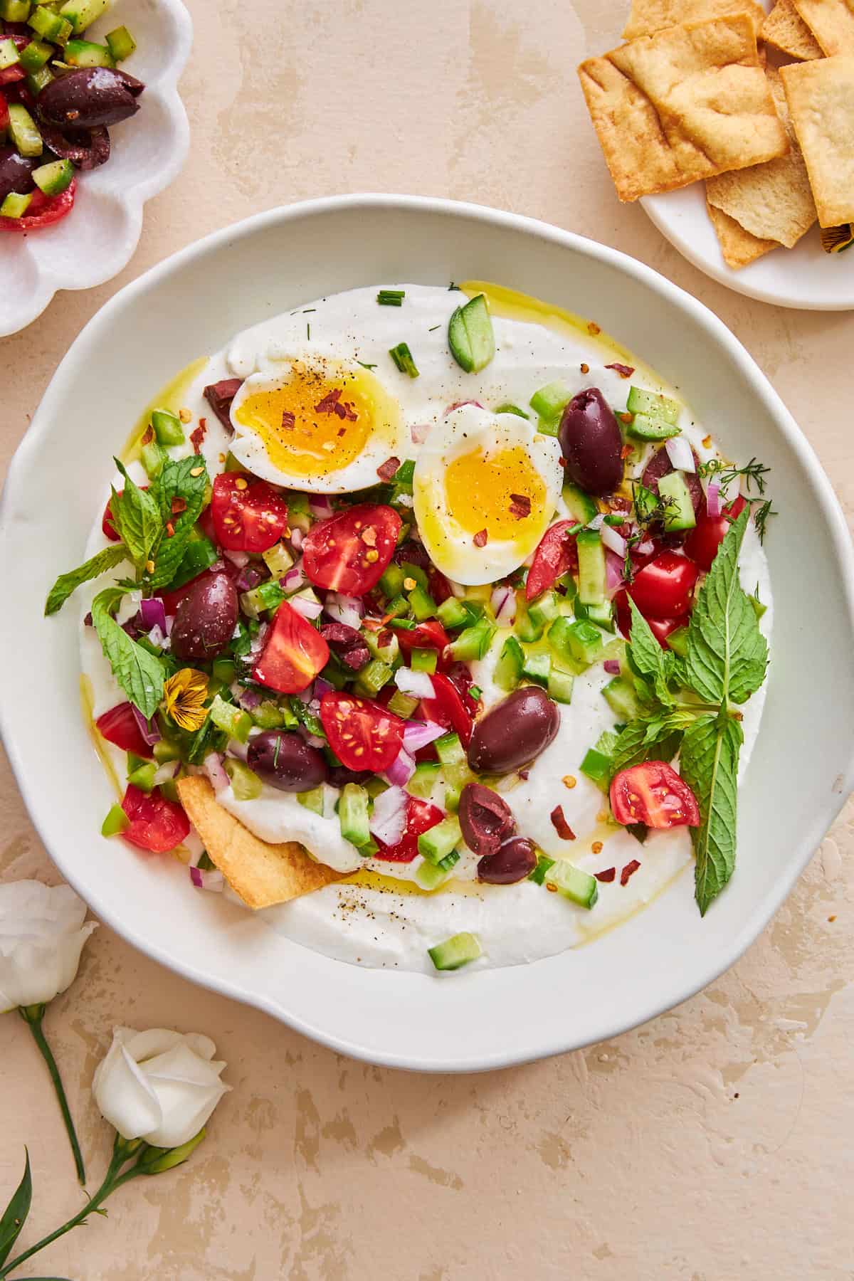 A bowl of whipped cottage cheese salad topped with an egg.