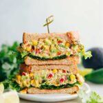 Mexican Street Corn Chicken Salad sandwiched between bread and lettuce.