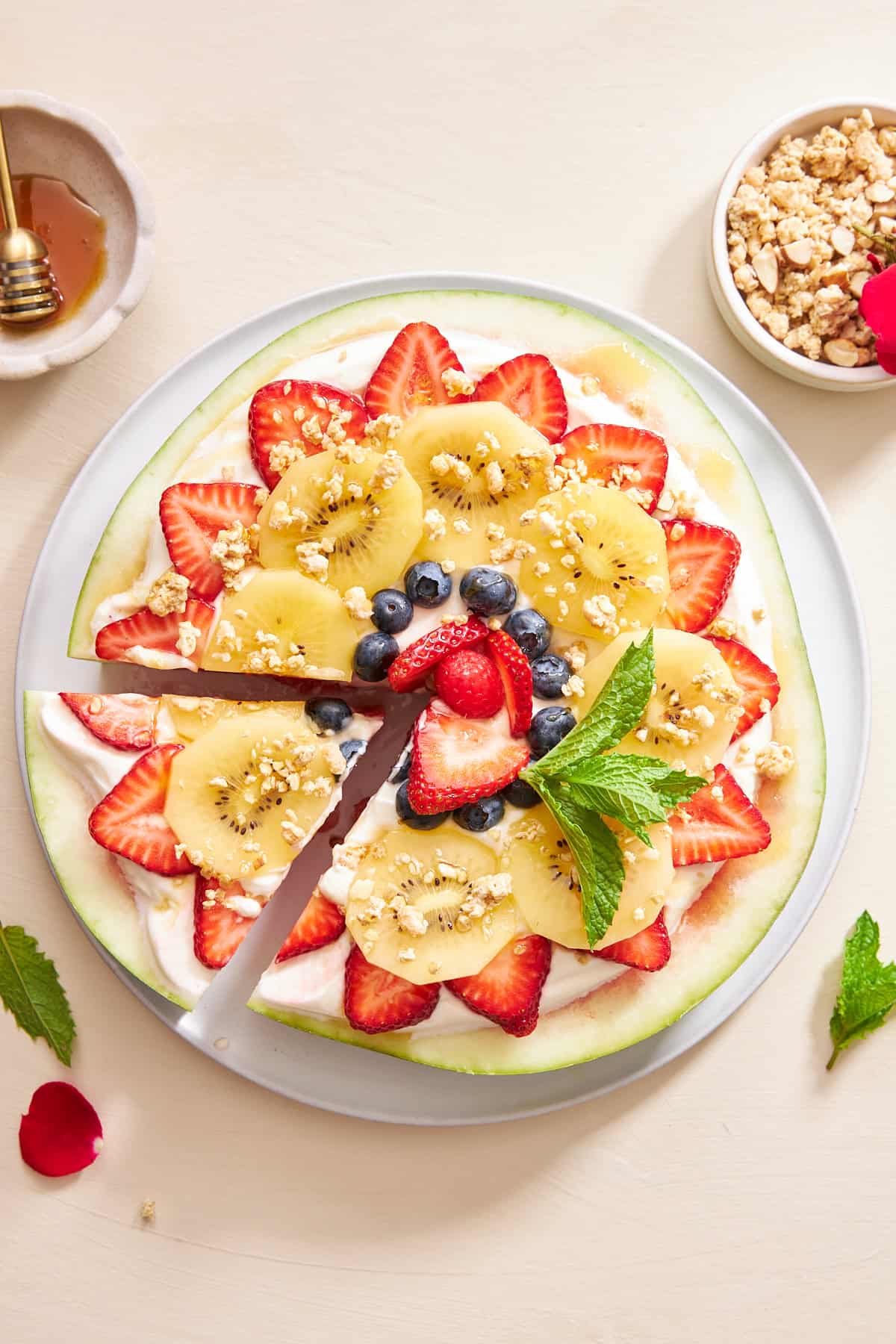 Watermelon pizza with a slice cut.