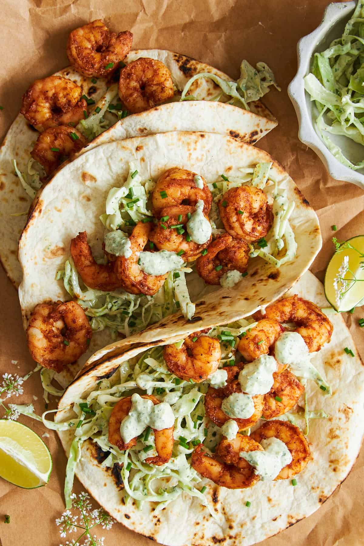 Three blackened shrimp tacos with slaw.