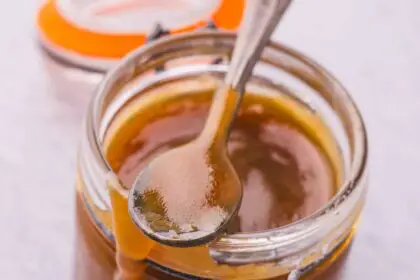 A jar of golden brown toffee sauce.