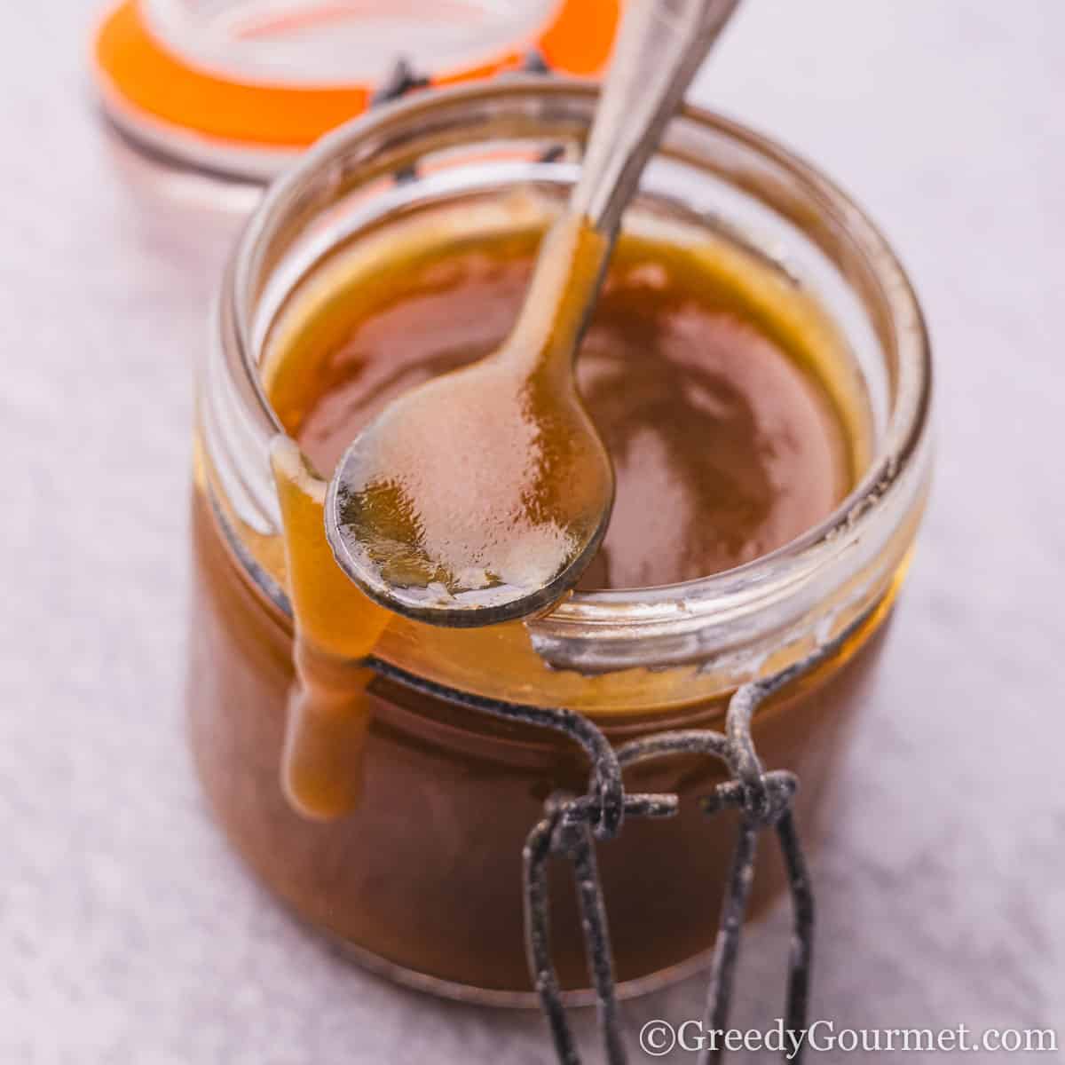 A jar of golden brown toffee sauce.