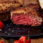 side view of a sliced filet mignon cooked to medium rare.