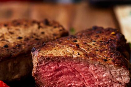 side view of a sliced filet mignon cooked to medium rare.