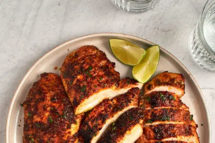 blackened chicken sliced on platter with green napkin