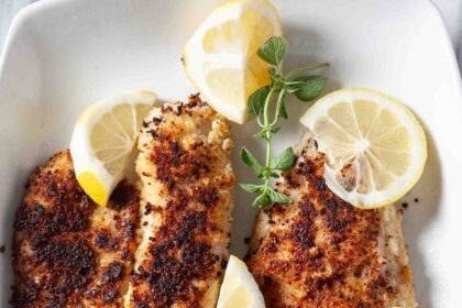 pan fried walleye served with lemon slices.