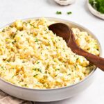 bowl of potato salad with wooden spoon