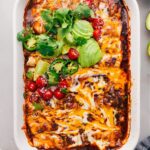 Crockpot or instant pot Shredded Beef Enchiladas fresh out of the oven with toppings.