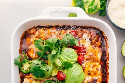 Crockpot or instant pot Shredded Beef Enchiladas fresh out of the oven with toppings.