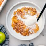 Apple Dump Cake on a plate with ice cream.