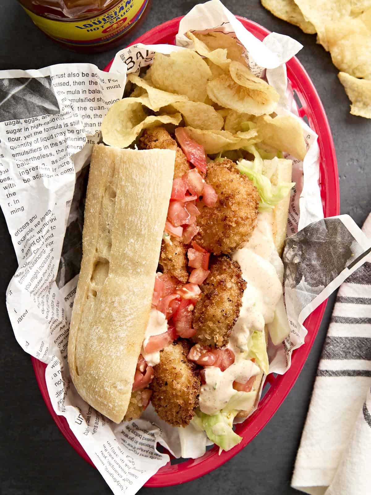 Ein Shrimps Po' Boy in einem Korb mit Kartoffelchips