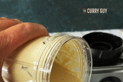 tahini sauce being poured into a jar.