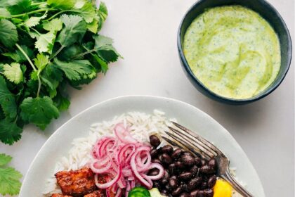 Mojo Salmon Bowls with all the toppings and dressing ready to be enjoyed.