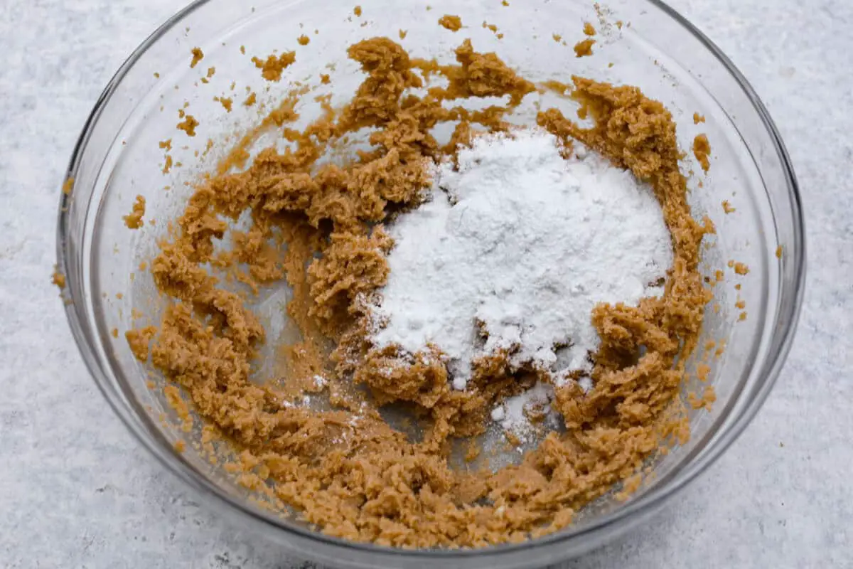 Overhead shot of beat butter and sugars with pudding mix on top. 