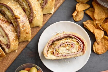 Overhead view of a muffaletta roll up on a plate