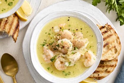 Shrimp and white bean stew in a bowl garnished with fresh herbs