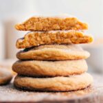 Brown Sugar Cookies stacked on top of each other, with one broken in half to reveal the delicious inside.