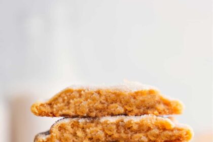 Brown Sugar Cookies stacked on top of each other, with one broken in half to reveal the delicious inside.