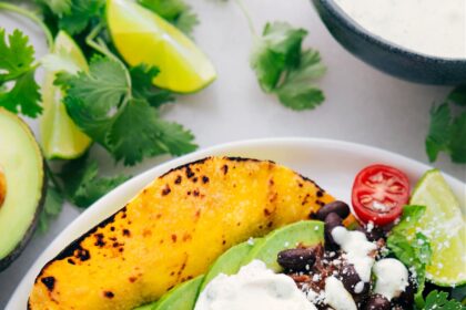 Shredded Beef Tacos on a plate with all the delicious toppings.