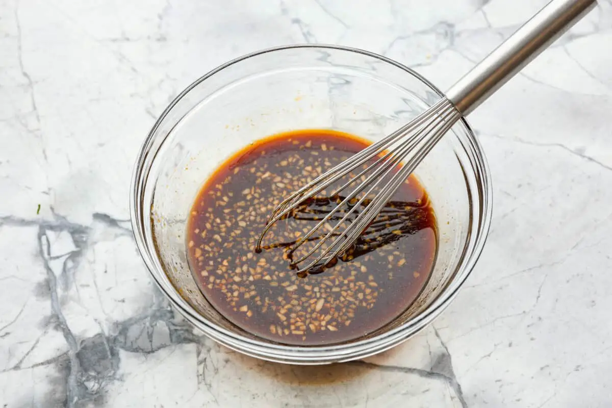 Overhead shot of marinade ingredients whisked in a bowl. 